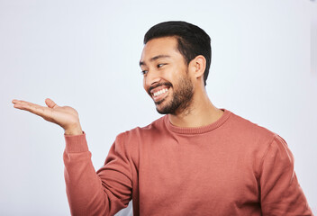 Aufkleber - Hand holding, space and happy asian man in studio with mockup, promotion or news on grey background. Smile, face and male person with platform for menu, product placement or sale announcement