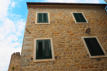 Herceg Novi, Montenegro, August 9, 2022. Architecture of the Adriatic coast of the Mediterranean. Boka-Kotor Bay. Modern and historical buildings of the old city and residential areas. Narrow streets.