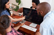 © Meeko Media - Three developers peer programming together in office, assisting peer review