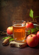 Apple juice in a glass and apples on light rustic background. Still life with apple juice. Generative AI