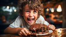 Happy, Smiling Child Eating A Chocolate Cake With Melted Chocolate On Top On A Wooden Table.