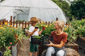 Son enjoys helping his mother with gardening.