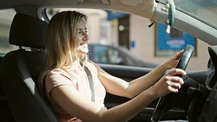 Sticker - Young blonde woman smiling confident driving car at street