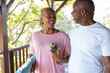 © Wavebreak Media - Portrait of happy senior african american couple holding yoga exercise mat on terrace