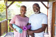 © Wavebreak Media - Portrait of happy senior african american couple holding yoga exercise mats on terrace