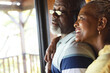 © Wavebreak Media - Happy senior african american couple embracing and looking out window at home, copy space