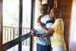 © Wavebreak Media - Happy senior african american couple embracing and looking out window at home, copy space