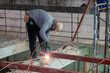 Man worker weld the steel at construction site.