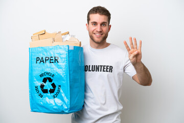 Wall Mural - Young caucasian man holding a recycling bag full of paper to recycle isolated on white background happy and counting four with fingers