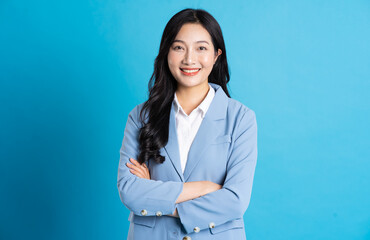 Wall Mural - portrait of asian business woman posing on blue background