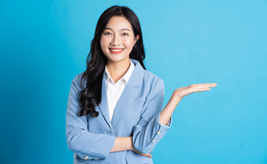 portrait of asian business woman posing on blue background