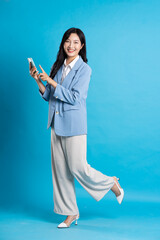 Wall Mural - Asian young businesswoman portrait on blue background