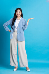 Wall Mural - Asian young businesswoman portrait on blue background