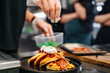 © pavel siamionov - woman chef hand cooking pancakes with meat, bacon and cheese sauce