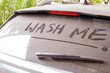 © Chalinee - dirty car rear widescreen covered with dust with wording WASH ME , car wash and car care concept , selective focus