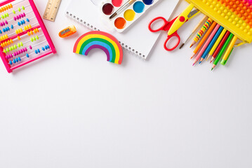 Canvas Print - Explore wonders of early childhood education with this top-down perspective: arrangement of colorful child stationery on white isolated background, providing copyspace for text or promotional material