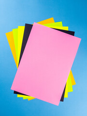 Poster - Colorful paper sheet background  isolated on blue, close up