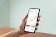 © patcharin.inn - Businessman trader using smartphone with stock market investments and graph on screen to analyze trading data, buy or sell and checking price on mobile application.