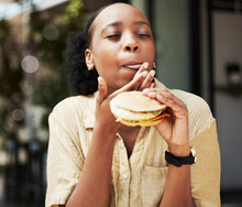 Hamburger, Fast Food And Black Woman Eating A Brunch In An Outdoor Restaurant As A Lunch Meal Craving Deal. Breakfast, Sandwich And Young Female Person Or Customer Enjoying A Tasty Unhealthy Snack