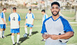 © Daniels C/peopleimages.com - Football player, phone and portrait at game on a field for sports and fitness app. Happy male soccer or athlete person outdoor for challenge, competition or motivation with online communication