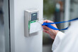 © Nadia L/peopleimages.com - Hand, key card and scan for security door, entrance or access control for safety in business, facility and property. Hands, electronic keys and laser reader or technology to lock or secure laboratory