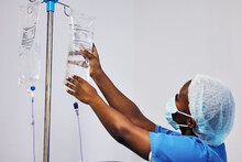 Hospital, Nurse With Face Mask And Black Woman With Iv Drip Medicine, Fluid Infusion Or Liquid Injection Bag. Nursing, Doctor Or Surgeon Monitoring Intravenous Medication, .anesthesia Or Healthcare
