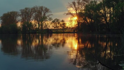 Wall Mural - Beautiful panoramic sunset reflecting on small lake in Germany.