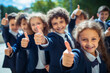 © Creative Clicks - Group of kids with their thumbs up. Going back to school and education concept
