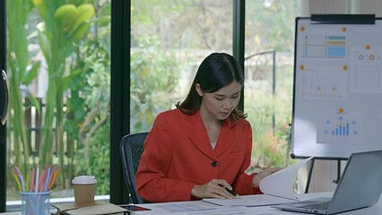 Wall Mural - Asian woman hand holding pen analysis the graph at the home office for setting challenging business goals And planning to achieve the new target.