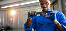 Professional Black Male Engineer Or Technician, Worker Examining Using Vernier Caliper Measure Of A Workpiece Steel For Checking Size In A Workshop Machine Factory.