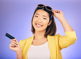 Sticker - Credit card, shopping portrait and woman in sunglasses, retail banking and finance, e commerce or payment. Happy customer, fashion model or asian person for debit pay on studio purple background