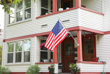 Wall Mural -  US flag waving proudly, representing patriotism and the spirit of American holidays, evoking a sense of national pride and unity