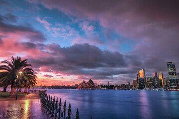 Wall Mural - sydney skyline with the opera house next to the city centre during sunrise with dramatic sky during 