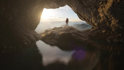 Wall Mural - adventurous man standing in cave on top of mountain. extreme adventure composite