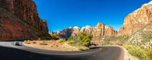Desert Serenity: Panoramic View Of An Empty Road Surrounded By Red Rock Canyon After A Storm, Presented In Captivating 4K Resolution
