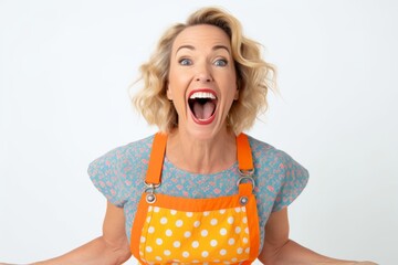 Canvas Print - Portrait of a happy mature woman in apron screaming over white background