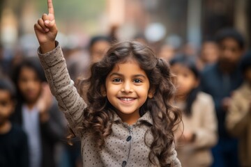 Canvas Print - The girl raises her hand for an answer in the classroom. Back To School concept. Backdrop with selective focus