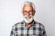 man in his 70s that is wearing a casual flannel shirt against a white background