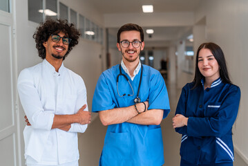 Wall Mural - Portrait of medical team standing in the hospital corridor smiling and looking at camera.