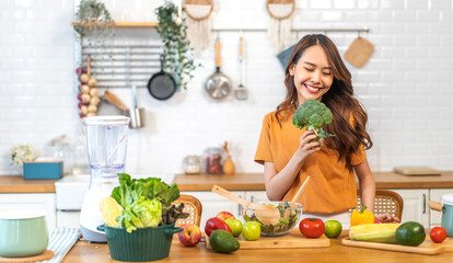 Wall Mural - Portrait of beauty body slim healthy asian woman having fun cooking and preparing cooking vegan food healthy eat with fresh vegetable salad on counter in kitchen at home.Diet.Fitness, healthy food