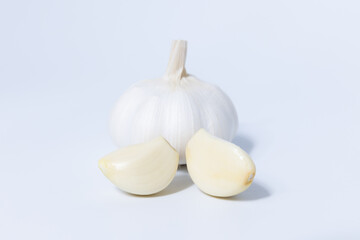 Wall Mural - Fresh garlic herb food on a white background.This culinary ingredient adds natural flavor and aroma to your meals. Ideal for gourmet cooking and food styling. A tasty addition to any recipe.