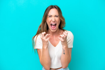 Wall Mural - Young caucasian woman isolated on blue background frustrated by a bad situation