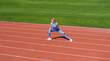 © Yevhen - Sports exercises and stretching in the stadium. Physical training girl. Fit girl do outward lunging. Physical training education. Sports lesson. Female runner stretching before workout
