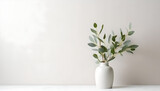 Fototapeta Kwiaty - Green eucalyptus leaves in vase on white table. Minimalist still life. Light and shadow nature. Place for text, copy space, empty space.