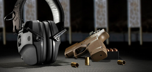 Wall Mural - Electronic hearing protection with pistol and ammo