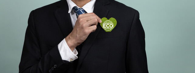 Eco-friendly corporate promoting sustainable and green business concept with businessman hold ECO symbol paper as environmental protection commitment using clean energy with zero CO2 emission. Alter