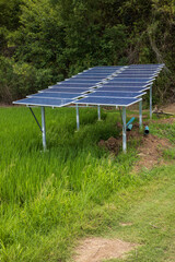 Views of many blue solar panels installed as roof shelters on steel poles.