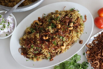 Wall Mural - Mutton Biryani prepared with spices layered between mildly spiced ghee rice with a generous sprinkle of caramelized onions and Mutton marinated in yogurt