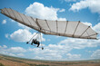 Vintage white hang glider flies to the sky