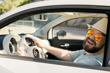 Happy Man Sitting In White Convertible Car With Beautiful View And Having Fun - Travel Summer Vacation And Rental Car Concept